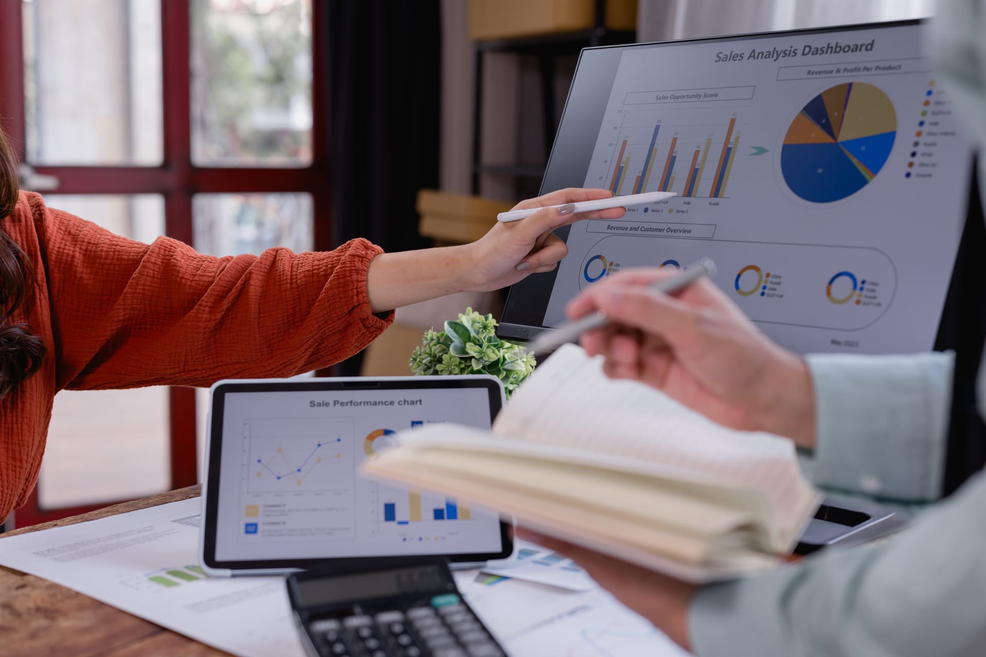 Marketing team reviewing a sales analytics dashboard together