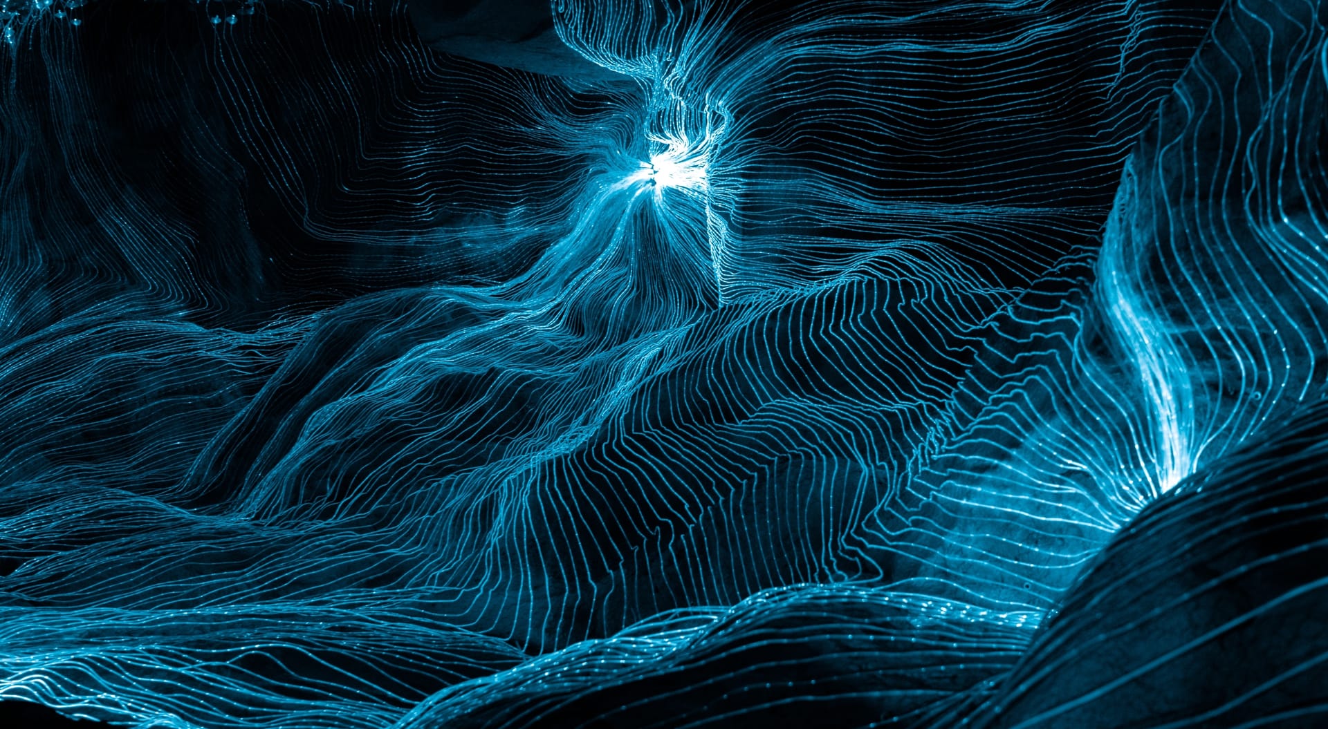Abstract woven lines of blue light on a dark background