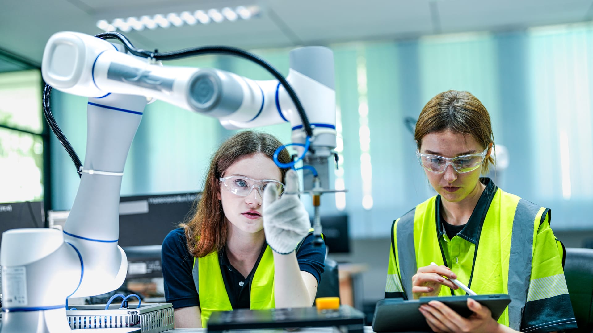 Engineers inspecting a collaborative robot arm in a lab