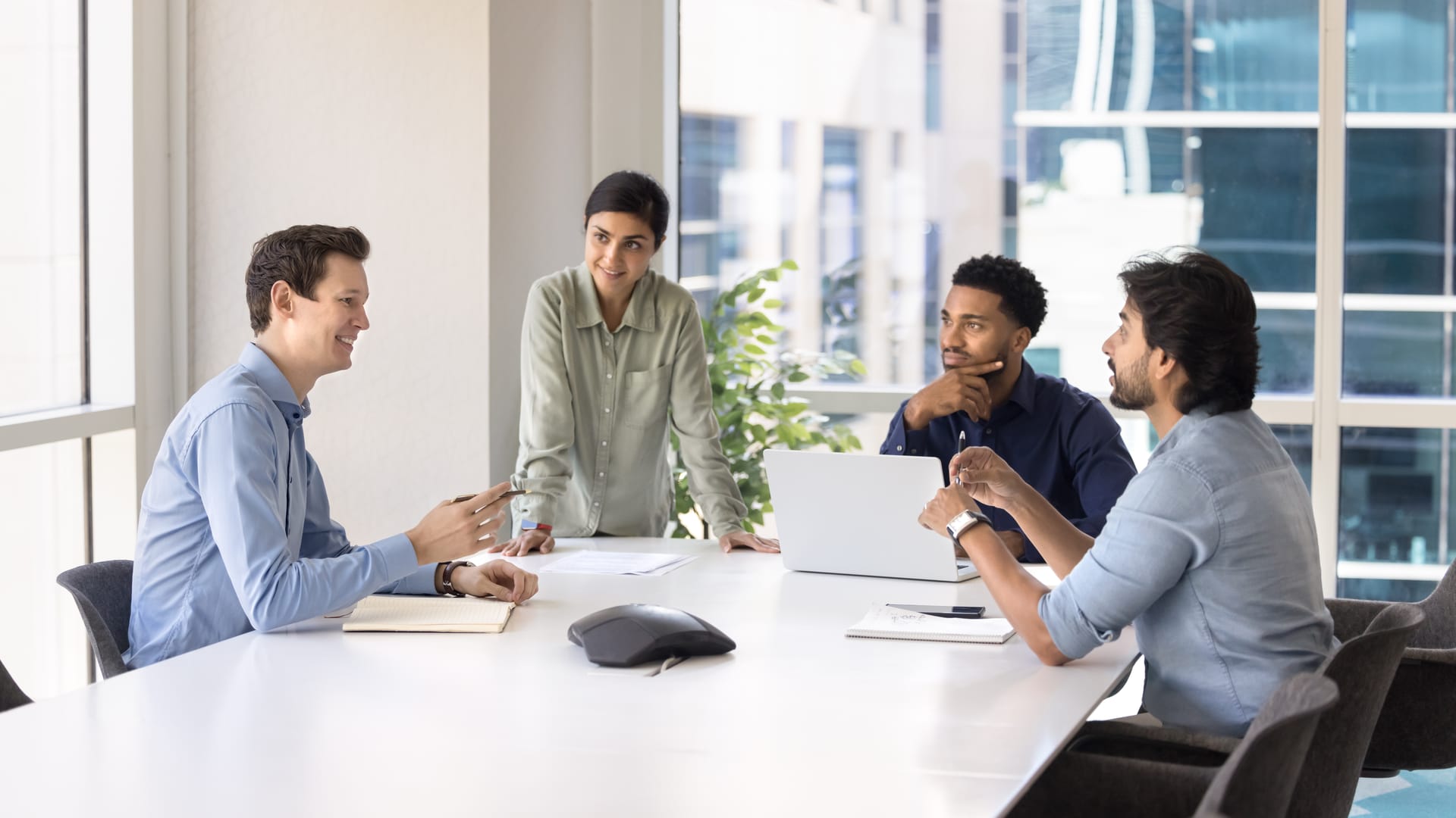 Team meeting around a table in a bright modern office