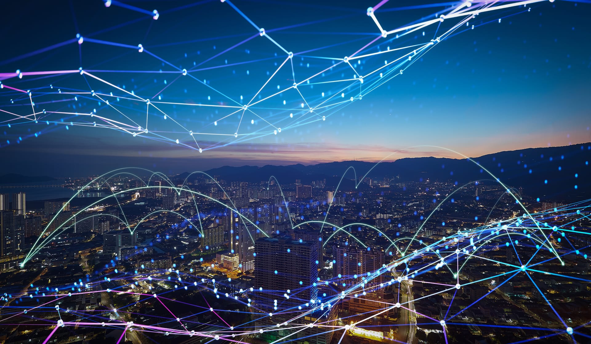 Network lines arcing over a city skyline at dusk