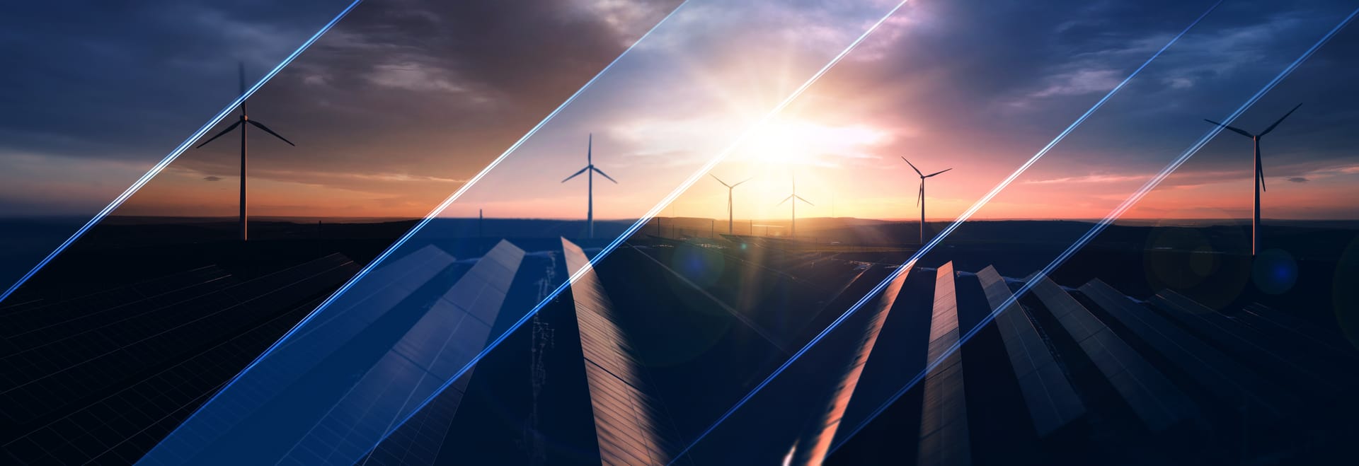 Solar panels and wind turbines against a sunset sky