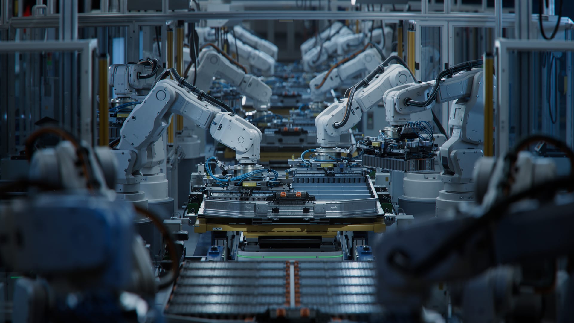 Row of white robotic arms on an automated production line