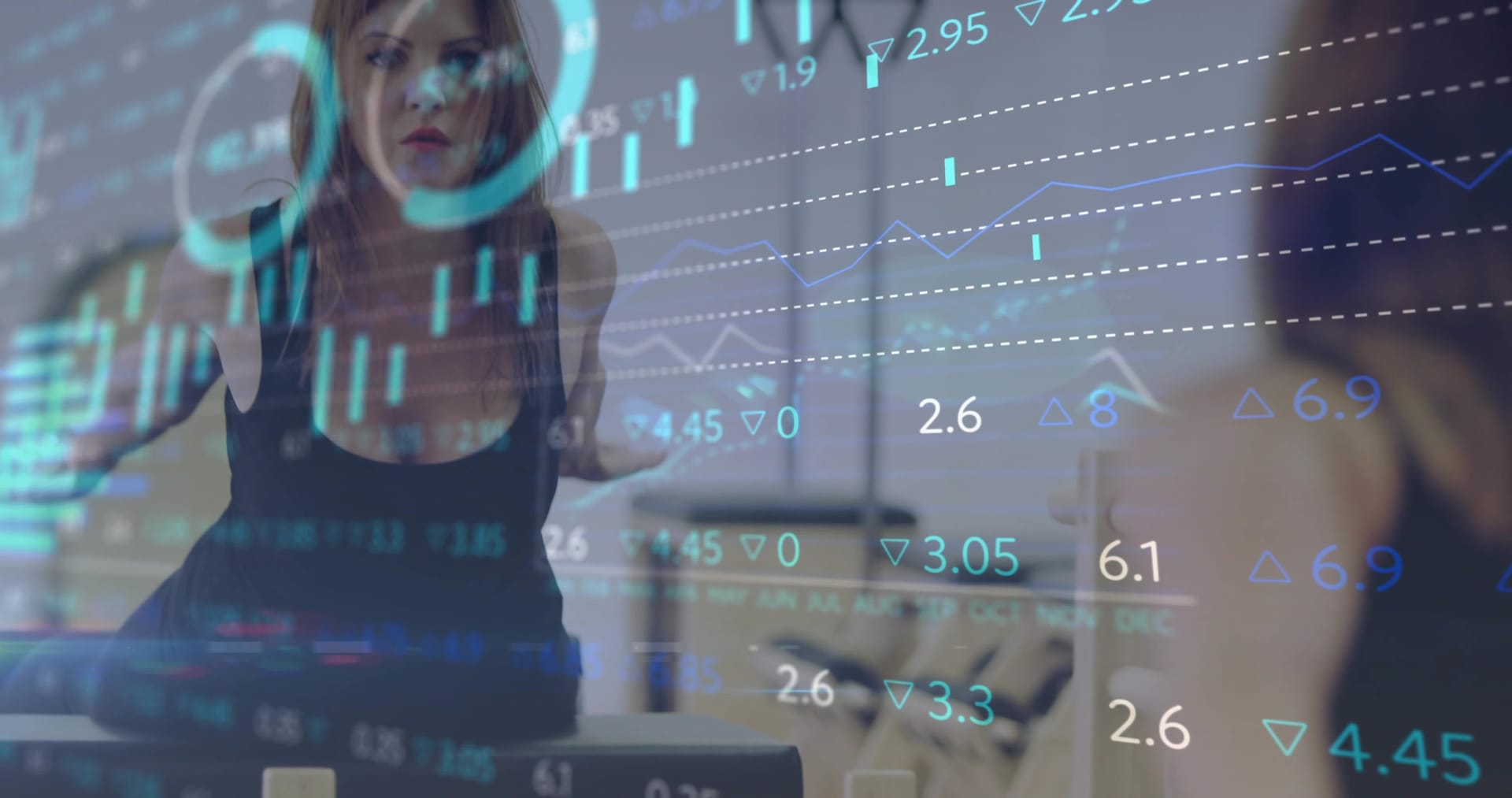 Analyst pointing at forecast charts on a glass display