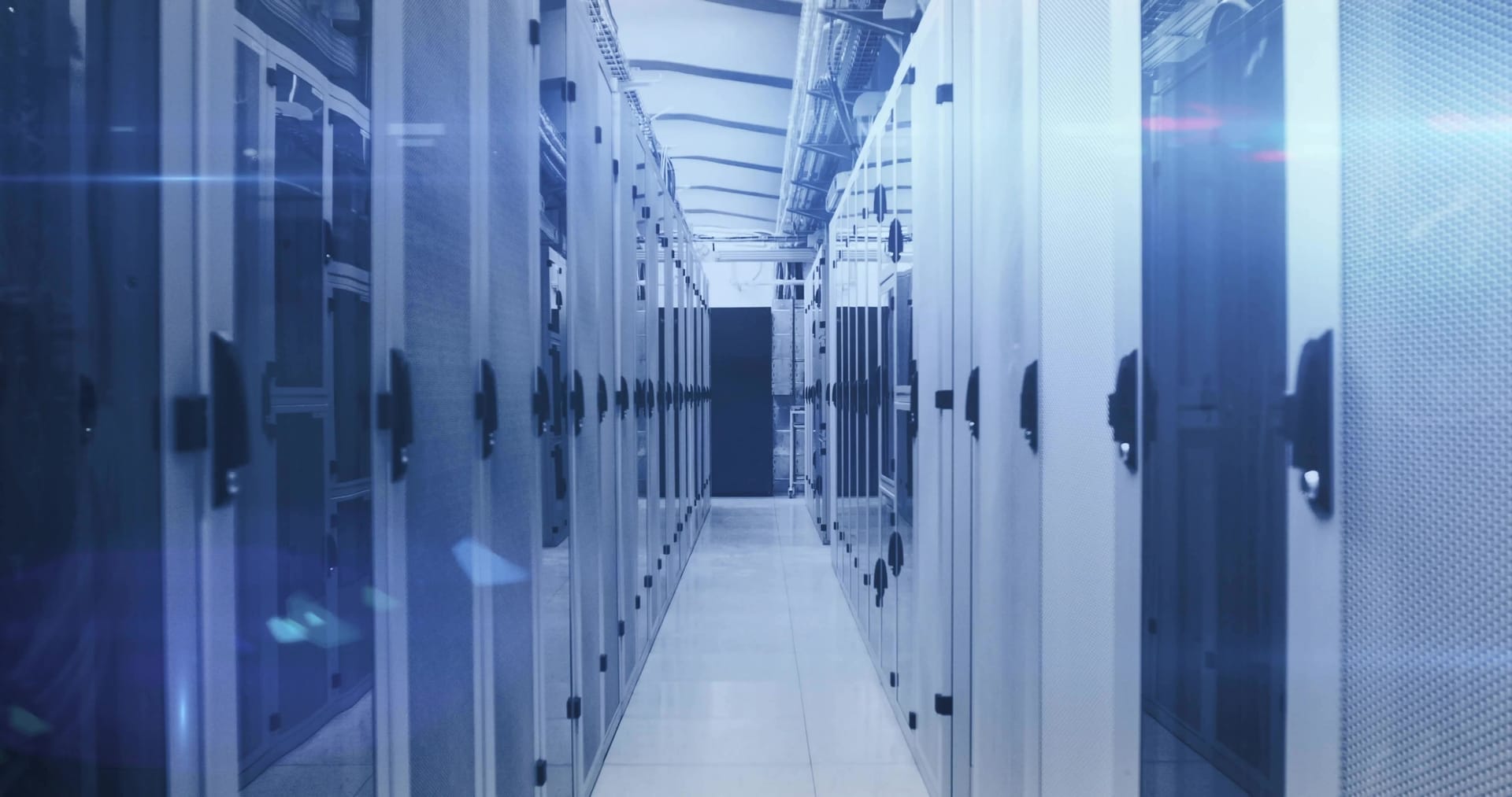 Central aisle of a data center with rows of server cabinets